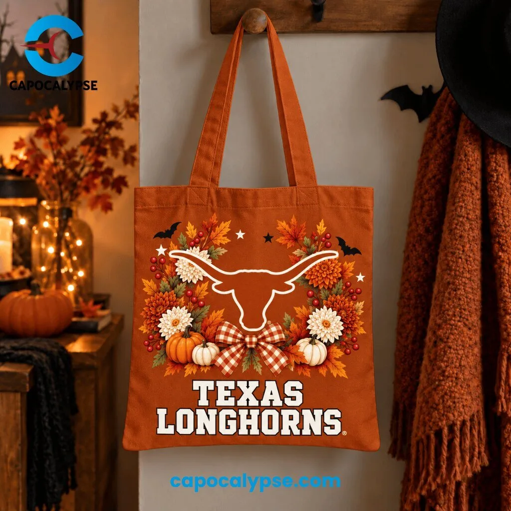 Texas Longhorns Autumn Harvest Tote Bag 1 Texas Longhorns burnt orange tote bag featuring iconic longhorn steer head with spread horns surrounded by autumn wreath of orange maple leaves, white chrysanthemums, red berries, cream pumpkins, and red gingham bow with black bats