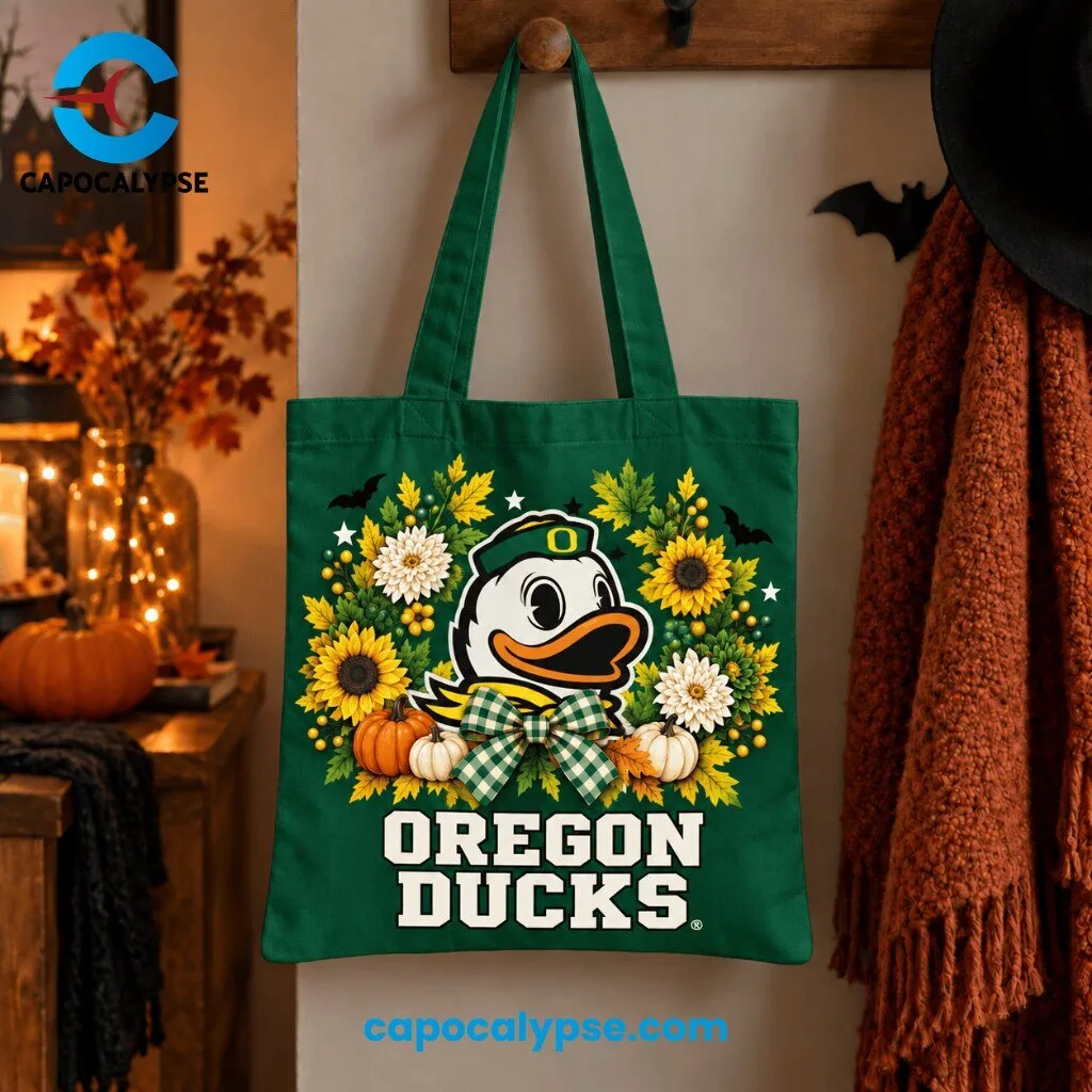 Oregon Ducks Autumn Harvest Tote Bag 1 Oregon Ducks forest green tote bag featuring white duck mascot with orange bill and yellow O logo surrounded by autumn wreath of orange maple leaves, white chrysanthemums, golden sunflowers, cream pumpkins, and green gingham bow